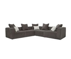 a large sectional couch with pillows on it's back and side facing each other