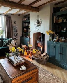 a living room filled with furniture and a fire place in the middle of a room