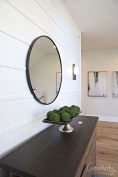 a bowl of broccoli sitting on top of a counter next to a mirror