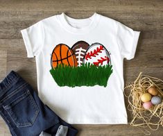 "Boy's Sports Easter Egg Shirt, Sports Easter Shirt, Easter Egg Hunt, Boy's Hunting Shirt, Football, Baseball, Hunting Shirt *Made to Order* All of our shirts are made to order with the sizes, colors and image specifications selected at the time your order is placed, and printed right here in the Dallas, Texas area, USA! Unless otherwise specified, our graphic tees are printed (not vinyl). We use a state of the art Direct to Garment printer which uses Eco-friendly water-based inks, similar to sc Easter Pail, Easter Shirts For Boys, Shirt Football, Boys Easter, Easter Shirt, Hunting Shirts, Bella Canvas Tees, Easter Egg Hunt, Egg Hunt