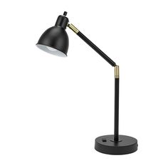 a black and gold desk lamp on a white background, with the light turned off