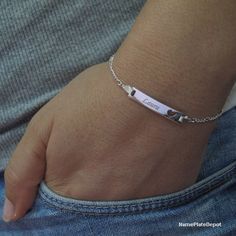 This personalized Girl's ID Bracelet with engraved name is made of Sterling silver (0.925) is the perfect gift for any girl! This fashionable item comes with a 5 inch Sterling Silver Figaro chain, which is extendable up to 6 inches. A silver ID bracelet is an excellent accessory for any outfit, and the pendant also features a cutout heart, making it perfect for showcasing your love!All our items are shipped in a beautiful free gift box ready for gift giving. (Ideal for Birthday, Anniversary, Wed Silver Personalized Heart Bracelet, Everyday Silver Name Bracelet For Valentine's Day, Silver Engraved Heart Bracelet, Adjustable, Silver Engraved Heart Name Bracelet, Silver Name Bracelet For Friendship, Silver Personalized Name Bracelet For Friendship, Engraved Name Bracelet For Mother's Day, Mother's Day Engraved Name Bracelet, Silver Heart Name Bracelet