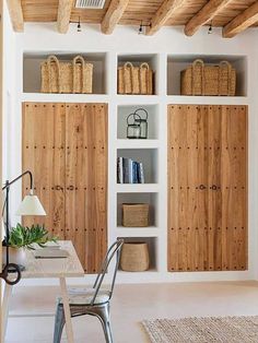 a room that has some bookshelves on the wall and chairs in front of it