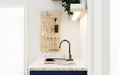 a kitchen with a sink and hanging utensils