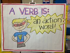 a sign that says a verb is an action word in front of a bulletin board