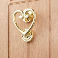 a heart shaped door handle on a wooden door