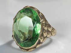 "Beautiful green paste gemstone ring from the Arts & Crafts movement of the late 19th century. The beautiful ring features classic Arts & Crafts handmade fashioning, with subdued floral detail reminiscent of the Art Nouveau period to which Arts & Crafts overlaps. The oval faceted green paste is bezel set and measures 18x6x13.6mm north to south. The gold tests at around 6K and can be easily sized up or down several sizes. All hallmarks carefully preserved during sizing or restoration. Please allo Cork Ornaments, Antique Collectors, Arts And Crafts Movement, Yellow Gold Rings, Classic Art, Patina, Beautiful Rings, Art Nouveau, Gold Rings