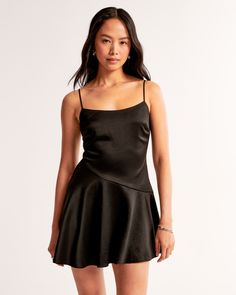 Elevate your wardrobe with the Abercrombie & Fitch Asymmetrical Hem Mini Dress, a stunning blend of sophistication and playful charm. This piece is designed to flatter, crafted from soft satin fabric that gracefully drapes your figure.

- Size: XS TALL
- Color: Black
- Material: Body and Lining - 100% Polyester
- Gender: Female
- Features: Scoop neckline, adjustable straps, asymmetrical dropped waistline, flirty skirt

Perfect for evening events or casual outings, this dress promises versatility Flirty Mini Dress With Adjustable Straps For Night Out, Satin A-line Slip Dress For Night Out, Satin Fit And Flare Mini Dress, Satin Fit And Flare Mini Dress For Cocktail, Flirty Satin Mini Dress, Cocktail Satin Fit And Flare Mini Dress, Flirty Mini Dress With Adjustable Straps For Cocktail, Chic Fitted Asymmetrical Satin Dress, Satin Fit And Flare Mini Dress For Party