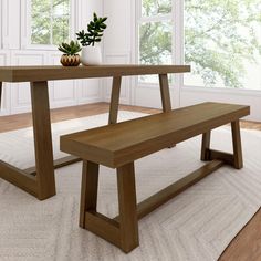 a wooden bench sitting next to a table on top of a white carpeted floor