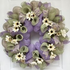 a purple wreath with white and green flowers