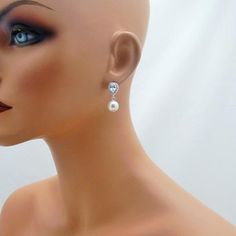 These gorgeous earrings feature a sparkling rhinestone teardrop accented with a large 10mm Swarovski pearl to complete the look. Pearl is available in 5 colors (white, ivory, light pink, light grey and dark grey). Comes in a gift box, perfect for gift giving. These measure approximately 1 inch long in total length. Shown on a life sized mannequin for reference. ALSO AVAILABLE AS CLIP ON EARRINGS: www.etsy.com/listing/713708747/clip-on-bridal-earrings-clipon-weddingSHIPPING: This item ships by US Elegant Teardrop Rhinestone Earrings, Elegant Teardrop Earrings With Rhinestones, Elegant Teardrop Earrings With Rhinestones For Gifts, Elegant Teardrop Earrings With Rhinestones As Gift, Formal Teardrop Rhinestone Bridal Earrings, Formal Teardrop Bridal Earrings With Rhinestones, Elegant Rhinestone Teardrop Earrings For Formal Events, Elegant Rhinestone Teardrop Earrings For Formal Occasions, Teardrop Crystal Pearl Earrings For Formal Occasions