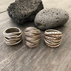 Three unique and powerful statement rings. The 3 of them are made in a braided, overlapping style that creates this unique chunky silver rings. Perfect everyday rings, that will rock your outfits, and are easy to match any other accessories. In one of the pictures, you can see which number represents each ring. Ring 1 is a size 8.5 Ring 2 is a size 8 Ring 3 is a size 8 All unique addition to your ring collection. To see more unique silver rings, click the link below https://www.etsy.com/shop/Aka Handmade Unique Rings With Thick Band, Unique Handmade Rings With Thick Band, Bohemian Wide Band Ring, Handmade Open Ring With Modern Twist, Handmade Open Ring With A Modern Twist, Unique Handmade Wide Band Rings, Unique Handmade Wide-band Rings, Thick Silver Ring, Male Ring