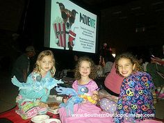 Friends gather on a blanket to watch a movie indoors at school.  -- Produced by Southern Outdoor Cinema, a cinema  equipment rental company in Atlanta. Friends Gathering, At School, Lily Pulitzer Dress