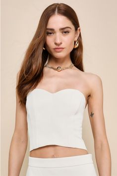 You'll be the best-dressed babe at the soiree in the Lulus Chic Invite Cream Strapless Bustier Crop Top! Lightweight woven twill shapes this chic top with a strapless, sweetheart neckline (with hidden no-slip strips) and a cropped bodice with a bustier-style silhouette and stylish seam details. Exposed zipper at back. Pair with the matching skirt for a complete look! Fit: This garment fits true to size. Length: Size medium measures 10.5" from top to bottom. Bust: Great for any cup size. Waist: F Elegant Summer Tube Top With Built-in Bra, Evening Crop Top With Built-in Bra For Spring, Chic Bandeau Tube Top With Boned Bodice, Chic Boned Bodice Bandeau Tube Top, Evening Bandeau Crop Top With Built-in Bra, Summer Lined Bodice Corset For Date Night, Fitted Bandeau Tube Top With Lined Bodice, Spring Tube Top With Corset Back And Sweetheart Neckline, Chic Tube Top With Boned Bodice For Night Out