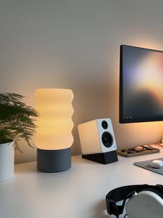 a computer monitor sitting on top of a white desk next to a keyboard and mouse