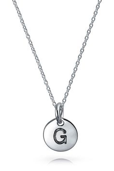 Personalize your look with this sterling-silver necklace complete with a circular initial pendant. 18" length Sterling silver Imported Classic Monogram Sterling Silver Charm Necklace, Classic Sterling Silver Monogram Charm Necklace, Classic Sterling Silver Initial Pendant Charm Necklace, Classic Sterling Silver Initial Round Pendant Necklace, Silver Circle Sterling Silver Charm Necklace, Silver Circle Charm Necklace In Sterling Silver, Silver Sterling Silver Circle Charm Necklace, Silver Monogram Dainty Charm Necklace, Silver Dainty Monogram Charm Necklace