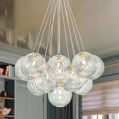 a chandelier hanging from the ceiling in a living room