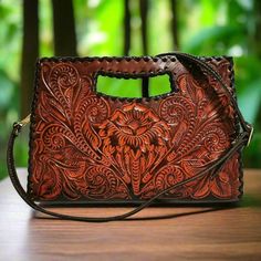 This rustic hand-tooled leather purse, featuring a stunning chiseled artisan design, adds a touch of vintage elegance to your daily ensemble. Ideal for carrying all your essentials, this purse is handcrafted with love and care by skilled artisans, offering a unique rustic charm rarely found in stores.  With exquisite chiseling on both sides, it makes the perfect gift for her on special occasions.  Measures: 🌹height: 20cm. 8  inch 🌹width : 29 cm.  11.4inch 🌹base:4 cm.    1.5 inch Large  adjust Brown Engraved Bags For Everyday Use, Engraved Brown Bags For Everyday Use, Traditional Engraved Shoulder Bag For Everyday, Traditional Engraved Shoulder Bag, Artisan Engraved Shoulder Bag For Everyday, Artisan Shoulder Bag With Engraving For Everyday Use, Artisan Shoulder Bag With Engraved Details For Everyday Use, Engraved Brown Shoulder Bag For Everyday Use, Brown Engraved Shoulder Bag For Everyday Use