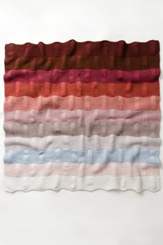 a multicolored blanket on a white background