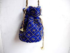 "Velvet evening purse with handwork of golden beads. Crossbody party bag with drawstring at the closure. It has an ethnic Indian touch in style and will go with western wears also like with dresses, jeans, etc. The bag is made up of velvet cloth in different color. It has a sling to hang it on the go. Can be used to gift some one or as fancy small sling bag in party or wedding. It can carry small things like mobile, wallet, etc. Dimension: maximum vertical length (of purse): 7\" vertical length Festive Bohemian Shoulder Bag Gift, Festival Clutch Shoulder Bag As Gift, Festive Clutch Shoulder Bag For Festivals, Gold Shoulder Bag With Dori Work For Gift, Festival Gift Clutch Shoulder Bag, Festive Clutch Shoulder Bag As Gift, Festive Bollywood Shoulder Bag Handmade, Gold Rectangular Shoulder Bag With Dori Work, Festive Pouch Evening Bag For Celebration