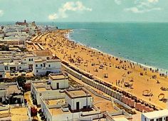 an aerial view of a beach with many people