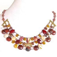 This gorgeous gemstone bib necklace is brimming with semi-precious drops in wine, pink and glowing ochre. Snap up this extraordinary statement piece online. Marsala Color, Fan Necklace, Nature's Bounty, Pink Rose Quartz, Handmade Beaded Jewelry, Jewelry Design Necklace, Moon Design, Red Jasper, Bib Necklace