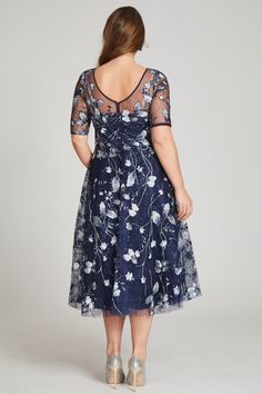 Perfect for cocktail attire events or black tie wedding, this tulle tea length navy and multicolored floral embroidered dress is both flattering and fun. The sheer illusion neckline elongates the torso and the a-line skirt narrows the waist. The light airy fabric makes dancing the night away a breeze. Tea length Elbow length sleeves Illusion neckline Pair with diamond or sapphire jewelry Fit: True to size Length: Knee to Tea length Undergarments: May be worn with any standard bra Black Tie Wedding Guest Dress Spring, Tulle Cocktail Dress, Tea Length Bridesmaid Dresses, Plus Size Gowns, Floral Cocktail Dress, Floral Embroidered Dress, Cocktail Attire, Embroidered Tulle, Illusion Neckline