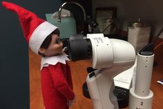 an elf is looking through a microscope at something