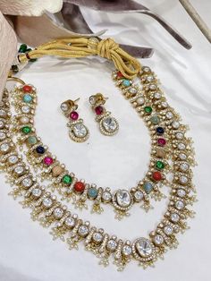 The handcrafted Navratan Polki layered necklace set is based on gold plating that celebrates the rich heritage of Indian jewelry. The Indian Polki necklace set is a masterpiece inspired by Bollywood jewelry to give you a royal look. The bold and bright design of the necklace is perfect for all the beautiful brides to be! *It's Handmade Indian Polki Kundan Necklace Set  * It's Handmade Kundan Stones Settings and 22k gold Plating as shown in picture. * It is Pure Ethnic Look with Antique Touch . s Double Liner, Polki Necklace Set, Kundan Jewellery Set, Bright Design, Polki Necklace, Royal Look, Ethnic Looks, Layered Necklace Set, Kundan Necklace