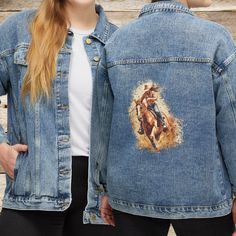 This is a great women's horse jean jacket. Your favorite barn cotton denim jacket for cool mornings and evenings. This Western Barrel Racing Horse Print Jacket is so unique and the perfect gift for a hard-to-buy horse mom or wife. The ability to print on denim is brand new so you will not find anything like right now. So unusual, so cute, and so YOU! I am so excited to be able to print my artwork and designs on this new jacket medium. Here are my custom-printed denim jackets for women. Crafted with a timeless design and a relaxed, oversized fit, this jacket is destined to be your go-to piece. Featuring classic details like a lapel collar, button-front closure, and long sleeves with buttoned cuffs, it exudes effortless style. Plus, with button-flap front patch pockets and front slant pocket Cowgirl Jean Jacket, Western Barrel Racing, Racing Horse, Cowgirl Jeans, Barrel Racing Horses, Printed Denim Jacket, Barrel Racing, Instagram Outfits, Horse Print