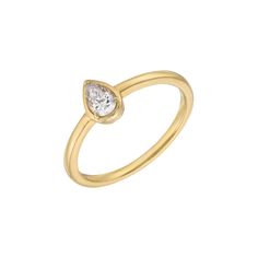 a yellow gold ring with a pear shaped diamond in the center, on a white background