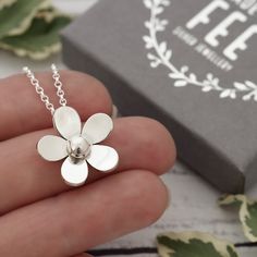 POSTAL DELAYS ARE COMMON DURING DECEMBER AND SADLY I CAN NOT GUARANTEE YOUR ORDER WILL ARRIVE IN TIME FOR CHRISTMAS.    This pretty sterling silver flower pendant necklace has been designed and is handmade by me, completely from scratch in my Sussex UK workshop using traditional silversmithing techniques.   First I create a design which I then transfer to silver sheet.   Then begins the process of carefully piercing out the flower with a very fine saw blade.  After, follows lots of filing and refining until I'm happy with the shape before doming and topping off with a hand-forged silver ball.   The flower pendant measures approximately 1.9cm at its widest point and is supplied on a lovely sterling silver mini rolo chain. Matching flower dangle earrings are available here: https://etsy.me/2 Flower Pendant Necklace For Mother's Day, Silver Flower Necklace For Anniversary, Anniversary Flower Charm Necklace, Handmade Dainty Sterling Silver Flower Necklace, Handmade Silver Flower-shaped Necklace, Delicate Silver Flower Charm Necklace, Sterling Silver Flower Charm Necklace For Mom, Handmade Silver Flower Necklace, Silver Delicate Flower Charm Necklace