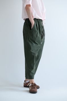 Manuelle Guibal Dandy Pant in color Military Road. Featuring an elastic waistband, pleats at front, pockets at sides and on back, ankle length, wide straight leg fit. 0 (Xsmall) - waist (before stretching elastic) - 22.5", length - 35" 1 (small) - waist (before stretching elastic) - 25", length - 35.5" 2 (medium) - waist (before stretching elastic) - 26.5", length - 36"3 (large) - waist (before stretching elastic) - 28", length - 36.5" 100% Cotton, Made in France. Green Tapered Leg Pants With Pull-on Style, Spring Parachute Pants With Elastic Waistband For Everyday, Relaxed Fit Pants With Gathered Waist For Spring, Relaxed Fit Wide Leg Bottoms With Gathered Waist, Relaxed Fit Parachute Pants With Elastic Waistband, Relaxed Fit Ankle-length Parachute Pants With Elastic Waistband, Relaxed Fit Wide Leg Bottoms With Pleated Waist, Relaxed Fit Bottoms With Pleated Waist And Wide Leg, Relaxed Fit Cotton Bottoms With Gathered Waist