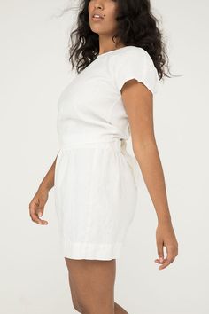 An artfully engineered top built for versatility and adaptability. This blouse can be worn with the knot in the front or the back, and also works wonderfully layered over tanks and dresses. Try tying it loosely for a relaxed fit, or tightly for a waist-cinching, pin-up silhouette. It boasts a low v-neck front- or full coverage in front with a low v-open back. Try tying the knot around the center front or back of your bra to help disguise it and keep the top securely in place. Simple rolled hems Fitted Tops With Gathered Waist For Daywear, Spring Beach Tops With Tie Waist, Summer Tie Waist Blouse For Day Out, Summer Linen Tops With Tie Waist, Chic Wrap Top With Tie Back, Summer Linen Top With Tie Waist, Linen Tie Waist Top For Summer, Spring Linen Tops With Tie Back, Spring Linen Tie Back Tops