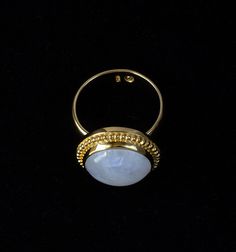 Gold Moonstone Ring Step into a world of ethereal beauty with this large Rainbow Moonstone ring handcrafted in 18K Gold Vermeil, with 18K Gold thickly coated over Sterling Silver. This captivating Balinese-style ring is a true testament to artisanal craftsmanship and the allure of Moonstones.Used in ancient rituals, Rainbow Moonstones are mystical sacred gemstones from India with beneficial healing properties to strengthen your intuition, provide protection and attract love. Every Moonstones is unique, so each ring is one of a kind.Handcrafted with passion and attention to detail, the Rainbow Moonstone Gold Vermeil ring is embellished with a Balinese-inspired design which adds a touch of exotic allure. The smooth wide band makes the ring comfortable to wear every day. Whether worn as a sym Handmade Fine Jewelry Yellow Gold Moonstone Ring, Handmade Yellow Gold Moonstone Ring, Handmade Yellow Gold Moonstone Ring Fine Jewelry, Celestial Gold Moonstone Ring, Handmade Fine Jewelry Moonstone Ring In Gold, Handmade Fine Jewelry Gold Moonstone Ring, Handmade Gold Moonstone Ring In Fine Jewelry Style, Gold Moonstone Open Ring With Natural Stones, Handmade Gold Ring With Moonstone