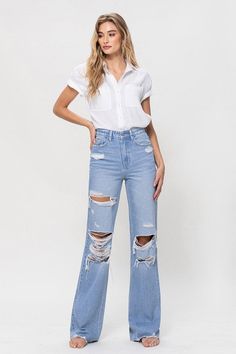 A nostalgic and stylish choice that pays homage to the iconic denim trends of the 90s. These jeans feature a high-rise waist, a non-stretch denim construction, distressed details, and a raw hemline, capturing the essence of vintage style.F. Rise: 11.5" / Inseam: 34" / Leg Opening: 20"Model is 5'9" and wearing size 26 Style: Vintage Print / Pattern: Light Denim Silhouette: Flare Fit: Relaxed Embellishment: Distressed Neck Line: NA Sleeve: NA Length: Full Length Closure: Zip Fly Lining: No Made In Distressed Cotton Flare Jeans For Everyday, Everyday Distressed Cotton Flare Jeans, Ripped Flare Jeans For Everyday Spring Wear, 90s Inspired Wide Leg Denim Jeans, Ripped Flare Jeans For Spring, High Rise Flare Jeans For Spring Streetwear, High Rise Ripped Flare Jeans For Everyday, 90s Style Denim Blue Spring Flare Jeans, 90s Style Cotton Jeans With Frayed Hem