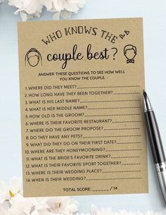 a couple's question card next to a pen and flowers