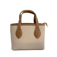 "Introducing the Harper mini leather tote bag in cream, designed by Laurenti New York. This compact and stylish bag is perfect for carrying all your essentials, from brunch to a night on the town. Crafted from high-quality leather, the Harper mini tote features a cream exterior that is both chic and versatile. The interior is lined with durable fabric and features ample space for storing your phone, wallet, keys, and other small items. The comfortable shoulder strap allows for easy, hands-free wear, while the gold-tone hardware adds an extra touch of elegance to this already stunning bag. Whether you're heading out for a casual brunch with friends or a fancy evening out, the Harper mini leather tote bag is the perfect accessory to complete any outfit. With its sleek and versatile design, y Cream Tote Box Bag With Removable Pouch, Cream Bucket Bag With Top Carry Handle For Shopping, Cream Bucket Satchel For Daily Use, Trendy Cream Travel Box Bag, Trendy Cream Box Bag For Travel, Trendy Cream Box Bag For Everyday Use, Everyday Cream Crossbody Box Bag, Trendy Cream Tote Box Bag, Cream Box Bag With Top Carry Handle For Shopping