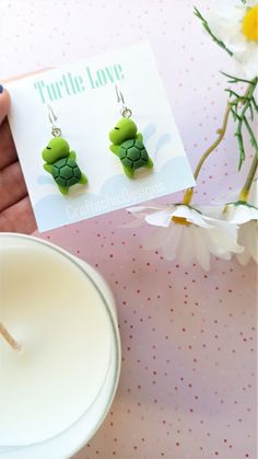 Super cute Turtle earrings, made from resin, in green colors. The closure is leverback, which is very comfortable and easy to wear, just click the back up and you're ready to show them off. The leverback makes sure the earrings will not fall out of your ear and it doesn't require additional pieces to make them secure. Packaging Materials: cardstock backing, holographic ziplock Size: 4 cm (total lenght) 1.5 cm (width) Find Me Here: Facebook: https://www.facebook.com/craftachicdesigns Instagram: h Adjustable Green Fun Jewelry, Whimsical Green Nickel-free Jewelry, Cute Handmade Green Jewelry, Cute Green Jewelry Gift, Green Handmade Fun Earrings, Green Fun Earrings For Gift, Green Fun Earrings For Gifts, Fun Green Earrings For Gifting, Fun Green Earrings For Gifts