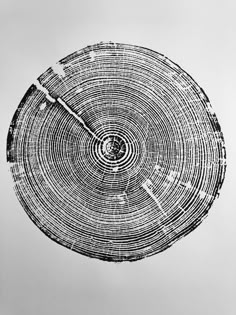 a clock made out of tree trunks on a white background with black and white lines