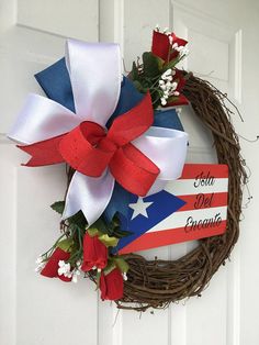 a patriotic wreath hanging on the front door