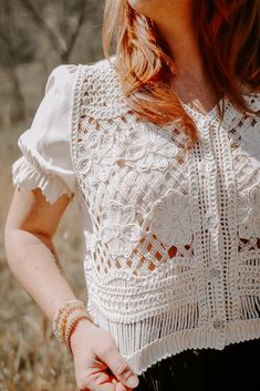 Be the life of the party in the Belize Top! This playful mesh top features delicate floral crochet details and a v-neck button down with contrast scallop elastic sleeves. Its vintage cream color and crop length add a unique touch. (Hot tip: pair with high-waisted jeans for a flirty and fun look!) Spring Festival Cotton Crochet Top, Cotton Crochet Top For Spring Festival, Spring Festival Crochet Cotton Top, Chic Crochet Trim Top For Festivals, Chic Fitted Crochet Top For Festival, Spring Festival Lace Top With Crochet Trim, Spring Festival Lace Top, Spring Festival Top With Crochet Trim, Vintage Lace Patchwork Top For Spring