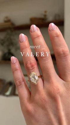 a woman's hand with a ring on it and the words meet valery