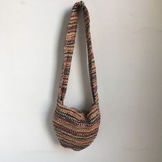 "Embrace the free-spirited vibe of the 1970s with this charming vintage shoulder bag. Crafted by hand, this one-of-a-kind purse features a beige base adorned with a vibrant woven pattern in red, black, and yellow. The thick strap ensures comfortable wear, while the fold-over closure adds a touch of practicality and style. Elevate your look with this timeless piece from the groovy era. era: 1970s measurements: approximately 10\" x 9\" x 2\" with a 15\" strap hang brand/maker: none marked conditio Retro Multicolor Hobo Shoulder Bag, Bohemian Brown Satchel Straw Bag, Casual Handwoven Shoulder Bag For Festivals, Bohemian Beige Crossbody Shoulder Bag, Bohemian Brown Straw Satchel Bag, Beige Bohemian Crossbody Shoulder Bag, Brown Bohemian Straw Bag For Everyday Use, Bohemian Cream Jute Bags, Bohemian Cream Hobo Bag For Travel