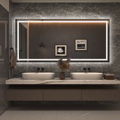 a modern bathroom with two sinks and a large mirror above the sink is illuminated by recessed lights