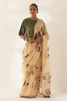 Whole wheat beige pure linen handloom saree with all-over multi colored floral patterns prints. Comes with contrast unstitched blouse piece.
Components: 2
Pattern: Printed
Type Of Work: Floral
Fabric: Pure Linen
Color: Beige
Other Details: 
Scalloped hem saree
Tassel edged palla
100 count handcrafted linen base
Dimensions:
Width: 45 inches
Length: 5.5 mtrs
Note:
The unstitched blouse is same as shown in the image.
The stitched blouse and all the jewellery worn by the model is not for sale.
Occas Saree Tassel, Draping Styles, Fashion Show Themes, Simple Saree Designs, Khadi Saree, Saree Draping, Simple Sarees, Unique Blouse Designs, Unique Blouse