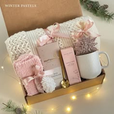 a gift box with coffee, soaps and other items in it on a table