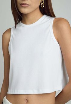 Size: one size fits xs/s and m  color: white  sleeveless top  48% polyester 48% rayon 4% spandex  dry clean recommended  by the nkc store    product measurements:  bust: 77.47cm / 30.50in  length: 38.73cm / 15.25in White Stretch Crop Top Tank, Basic Ribbed Sleeveless Top, Fitted White Tank Top For Everyday, Basic Sleeveless Ribbed Top, Chic White Cropped Tank Top, White Stretch Tank Crop Top, White Seamless Tank Top For Layering, White Cropped Stretch Tank Top, Fitted White Basic Tank Top