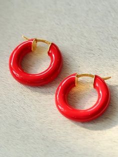 Add a pop of color to your accessory collection with our Enamel Glazed Hoops Earrings! These vibrant hoops are perfect for elevating any outfit and will make you stand out from the crowd. The enamel coating adds a glossy shine to these already eye-catching earrings. Perfect for any fashion-forward individual looking to make a statement! Metal: 18ct Recycled Gold Plated Vermeil on Recycled Sterling Silver Dimensions: 25mm x25mm Weight: 8.5g Gold Enamel Dangle Hoop Earrings, Red Enamel Hoop Earrings Gift, Elegant Enamel Hoop Earrings, Colorful Enamel Hoop Earrings, Unique Red Enamel Earrings, Sliver Earrings, Geometric Hoop Earrings, Edison Pearls, Tiger Eye Stone