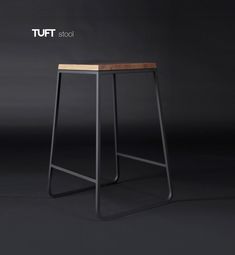 a stool made out of metal and wood with the words tuft stool on it